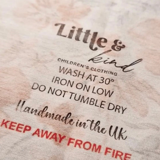 Fabric label with care instructions and text on a textured fabric background
