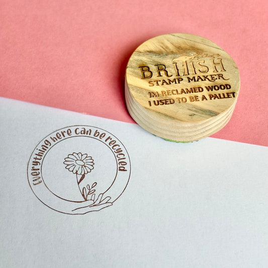 Circular wooden recycled design rubber stamp, 'British Stamp Maker' text, daisy and hand illustration, 'everything here can be recycled' message