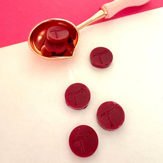 Ruby hand-poured sealing wax beads, close-up view