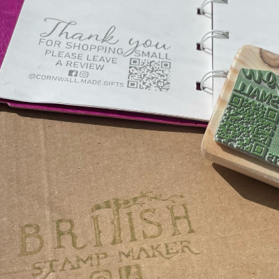 Thank you for shopping small please leave a review QR code stamp including instagram and facebook icons and @cornwall.made.gifts eco rubber stamp on a pink filofax notebook.