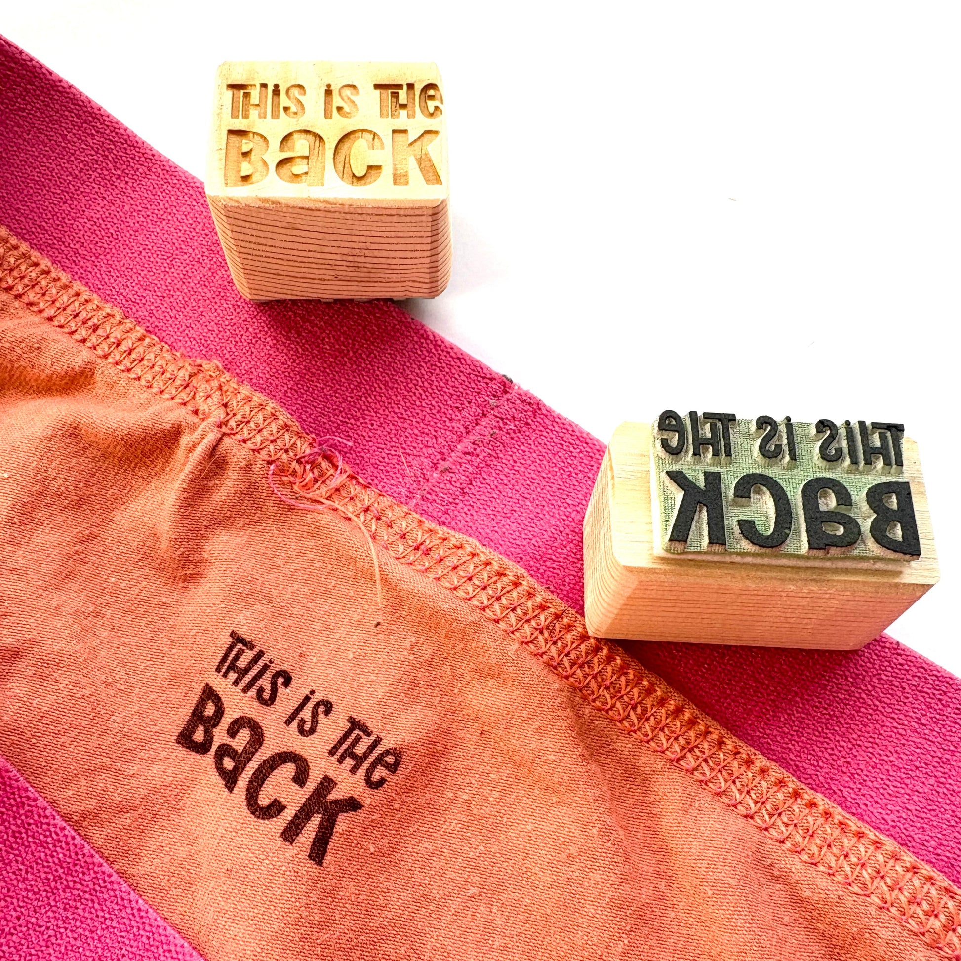 This is the back fabric stamp onto the back of  orange and pink shorts