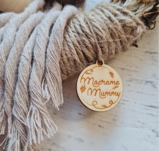 Macrame mummy round plywood laser cut tag engraved and attached to macrame wall hanging decoration. 